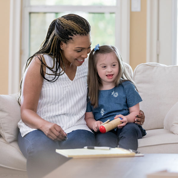 woman sitting with young girl that has a learning disability